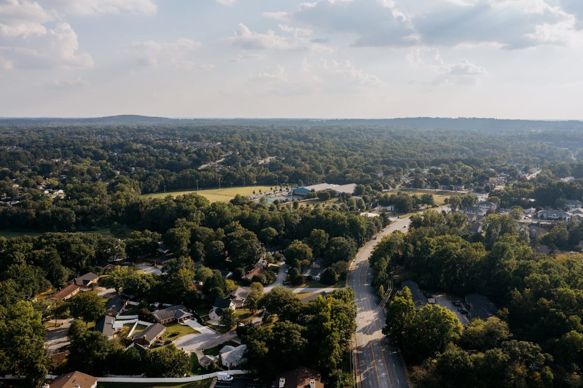 Aerial view of a master-planned suburban community with tree-lined streets