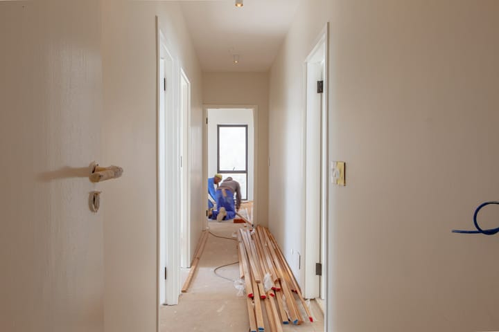 Workers renovating the exterior of a house